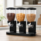 Dispensador de cereal triple en negro, con tres depósitos llenos de distintos cereales, sobre una mesa de cocina
