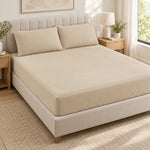 Forro ajustable liso con 2 sobrefundas bordadas, color Beige – forro ajustable y 2 sobrefundas en la cama