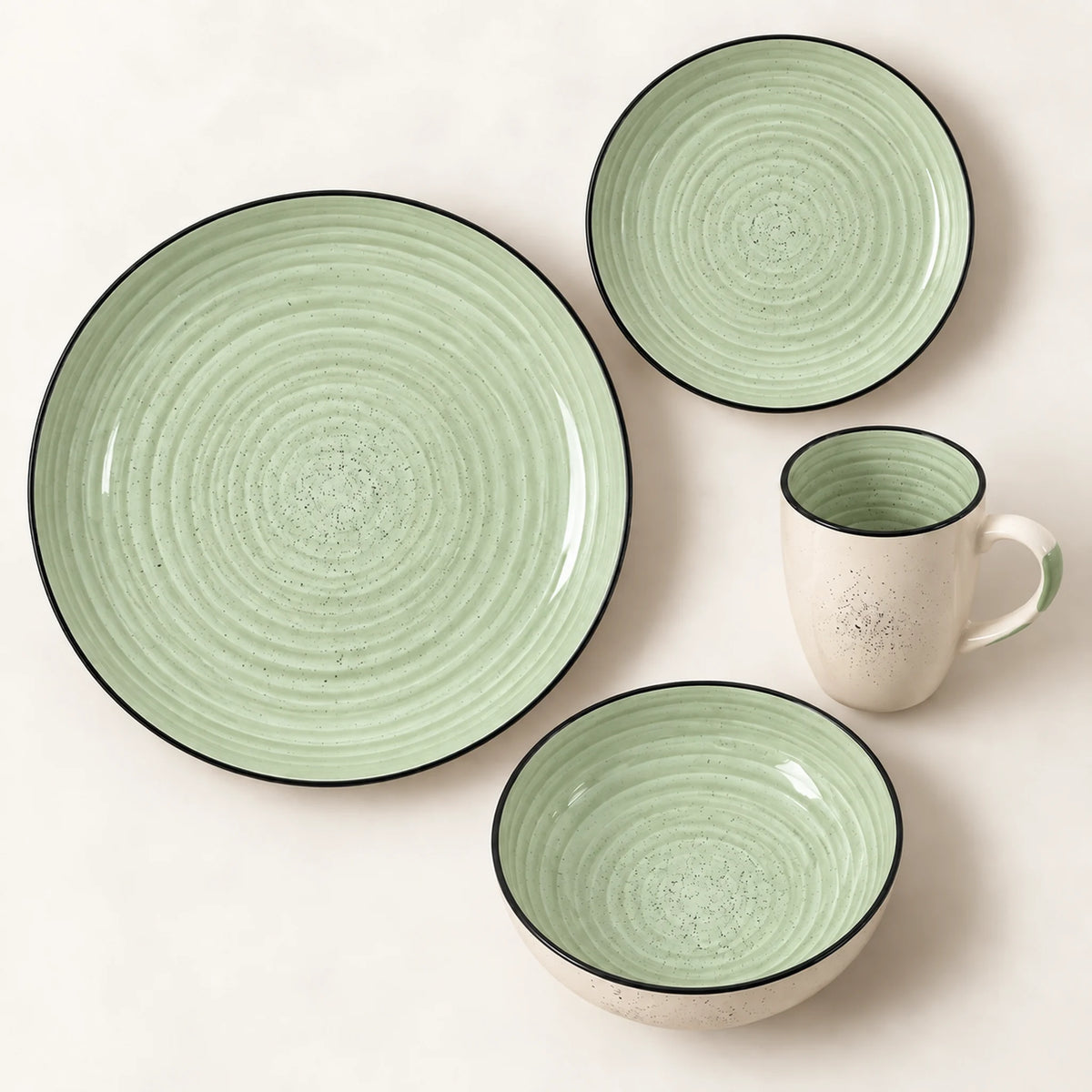 Vista superior de un puesto de la vajilla Lotus color Verde Salvia: plato llano, plato de postre, tazón y taza