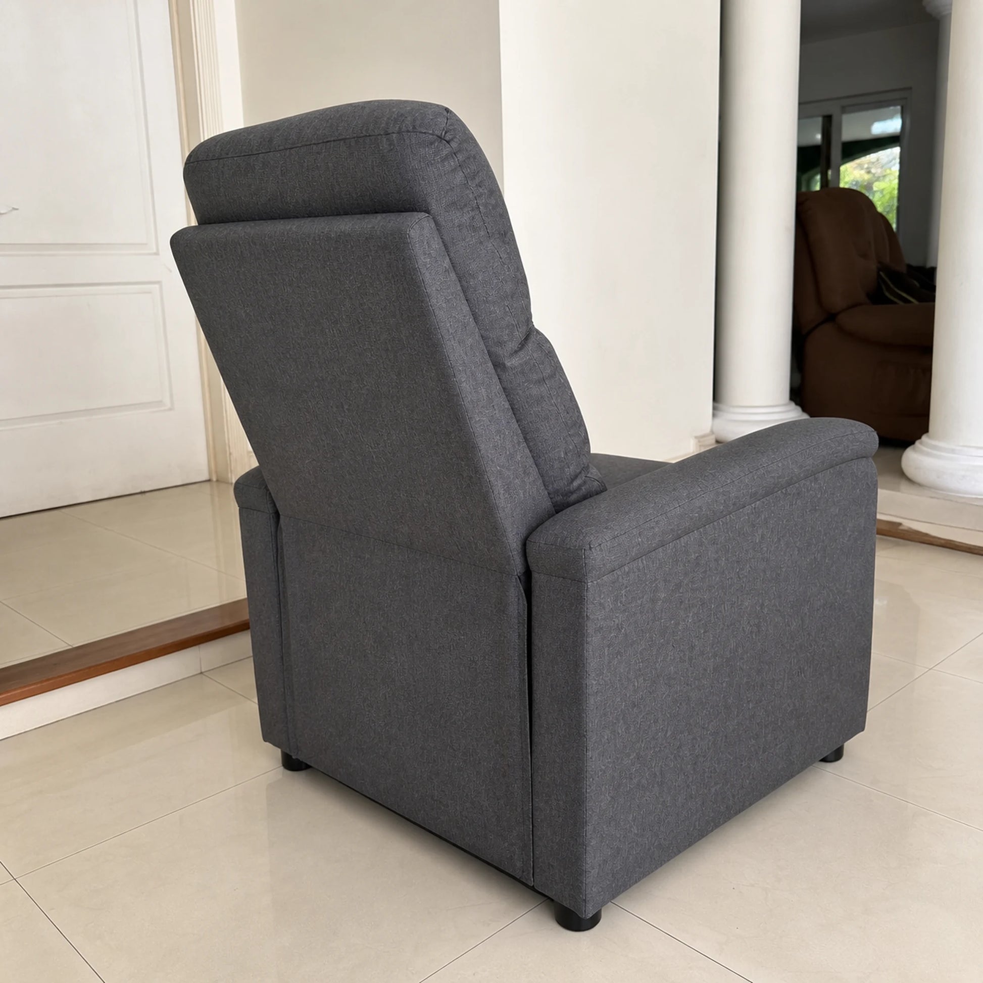 Vista posterior y lateral del sillón reclinable tapizado en gris