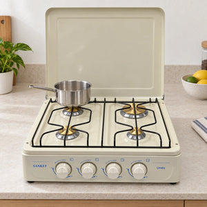 Cocina a gas Sankey Linda color beige sobre una encimera de cocina, con una olla en uno de sus quemadores
