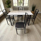 Comedor 4 puestos DT-Y7007 Ambienta Home Decor, vista frontal con mesa tipo mármol blanco y 4 sillas de metal negras con asiento negro.