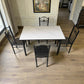 Vista superior del comedor 4 puestos Ambienta Home Decor DT-Y7007: mesa rectangular 120x70 cm con cubierta tipo mármol blanco y sillas negras.