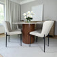 Mesa redonda Ø120 cm efecto mármol con base cilíndrica en nogal y sillas tapizadas beige (patas metálicas negras), modelo DT-04-2258, vista lateral derecha con florero.