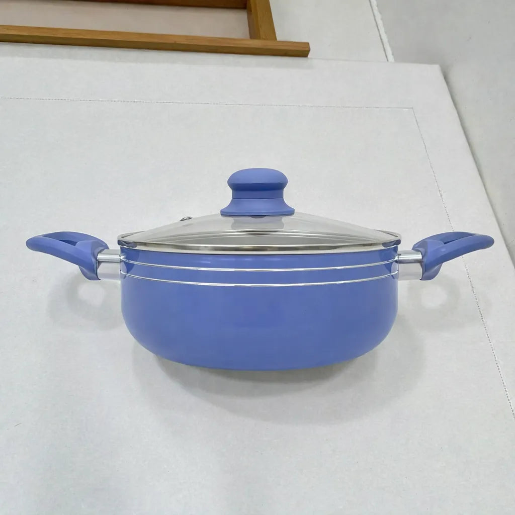 Olla/cacerola Bergmann azul con tapa de vidrio y asas laterales, vista frontal sobre superficie clara.