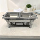 Chafing dish doble de acero inoxidable sin tapa, con dos bandejas internas vacías para servir alimentos calientes.