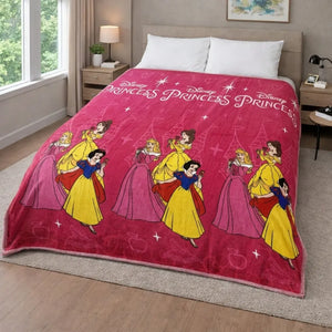Frazada piel de borrego infantil Disney Princess color fucsia, tamaño 230x190 cm y 1500 g, colocada sobre cama; diseño con princesas clásicas y texto “Disney Princess”, vista en recámara.