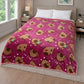 Frazada piel de borrego infantil color fucsia con estampado de caritas de ositos y texto “Hi”, 230x190 cm y 1500 g, colocada sobre cama; patrón repetido con detalles blancos.