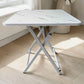 Mesa plegable multiusos blanca tipo mármol Ambienta Home Decor con patas blancas y superficie cuadrada de 60x60 cm, altura 72 cm, vista frontal completa, SKU 41346.