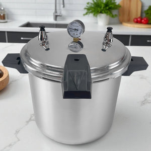 Olla de presión Sankey de 22 litros en aluminio con manómetro y asas negras, vista frontal sobre encimera de cocina.