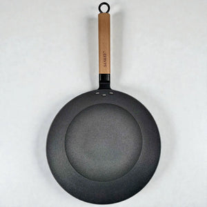 Vista superior del wok Sankey de hierro fundido negro 30 cm (12”), con mango de madera y base interior tipo panal sobre fondo blanco.