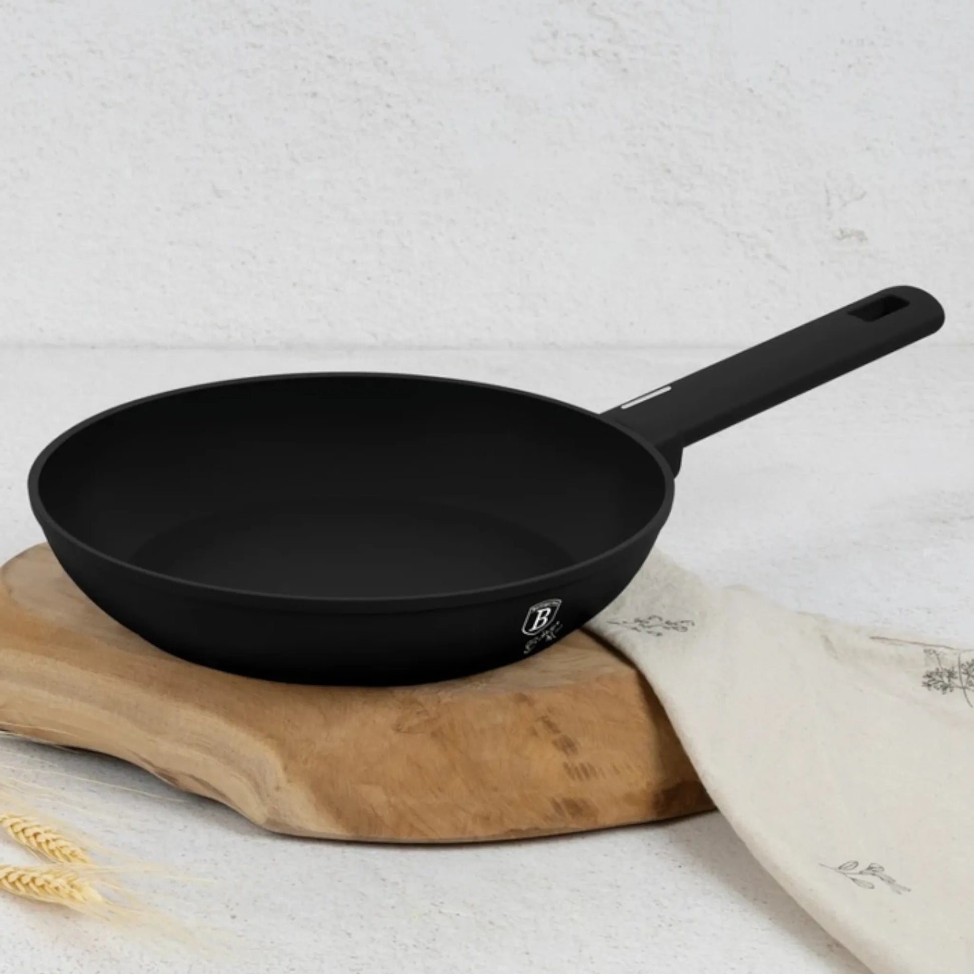 Sartén Berlinger Haus BH-8195A negro mate con mango soft-touch sobre tabla de madera en cocina clara.