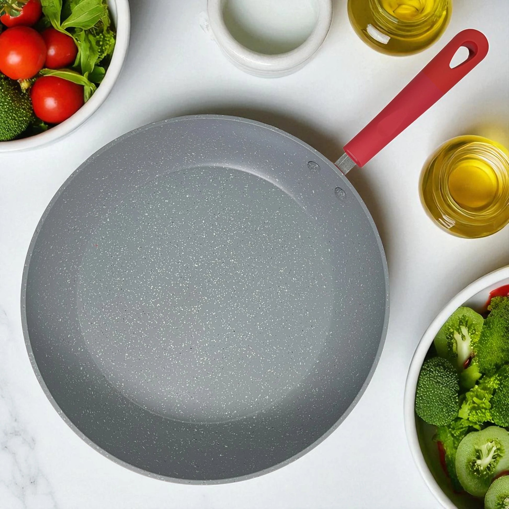 Vista superior del interior marmolizado gris antiadherente de un sartén Estrella Gourmet 30 cm, detalle del recubrimiento de 3 capas.