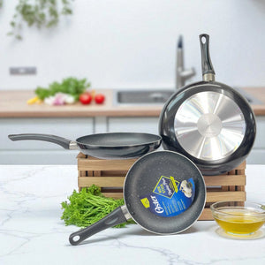 Vista trasera del set de 3 sartenes Oster antiadherentes color negro con efecto marmoleado, mostrando base metálica y medidas 30.5, 24 y 20 cm.