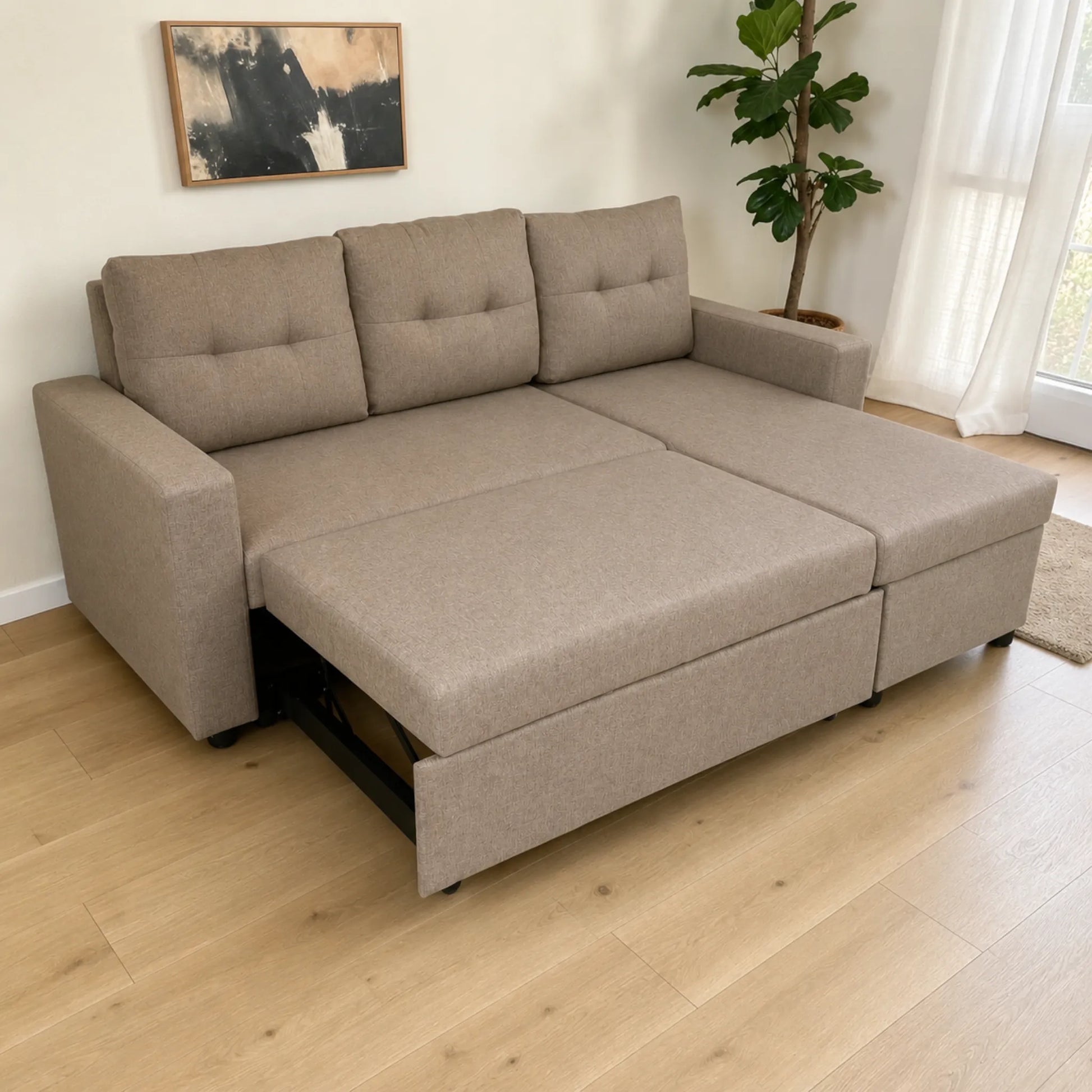 Sofá cama 2 en 1 Ambienta Home Decor color taupe con extensión deslizable parcialmente abierta, mecanismo metálico visible, chaise izquierda y amplia superficie para descanso en sala moderna.