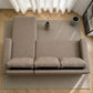 Vista superior del sofá cama 2 en 1 Ambienta Home Decor color taupe en configuración con chaise izquierda, tres cojines removibles, brazos rectos y diseño moderno sobre alfombra en sala contemporánea.