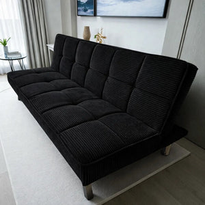 Sofá cama tapizado en terciopelo acanalado Negro, vista en tres cuartos desde la derecha, patas metálicas, Ambienta Home Decor, 175×75×55 cm.