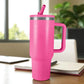 Termo rosa de acero inoxidable 1200 ml con asa y tapa de rosca con pajilla, colocado sobre escritorio junto a cuaderno.